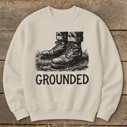 Cream sweatshirt with black graphic of work boots and the word "GROUNDED".