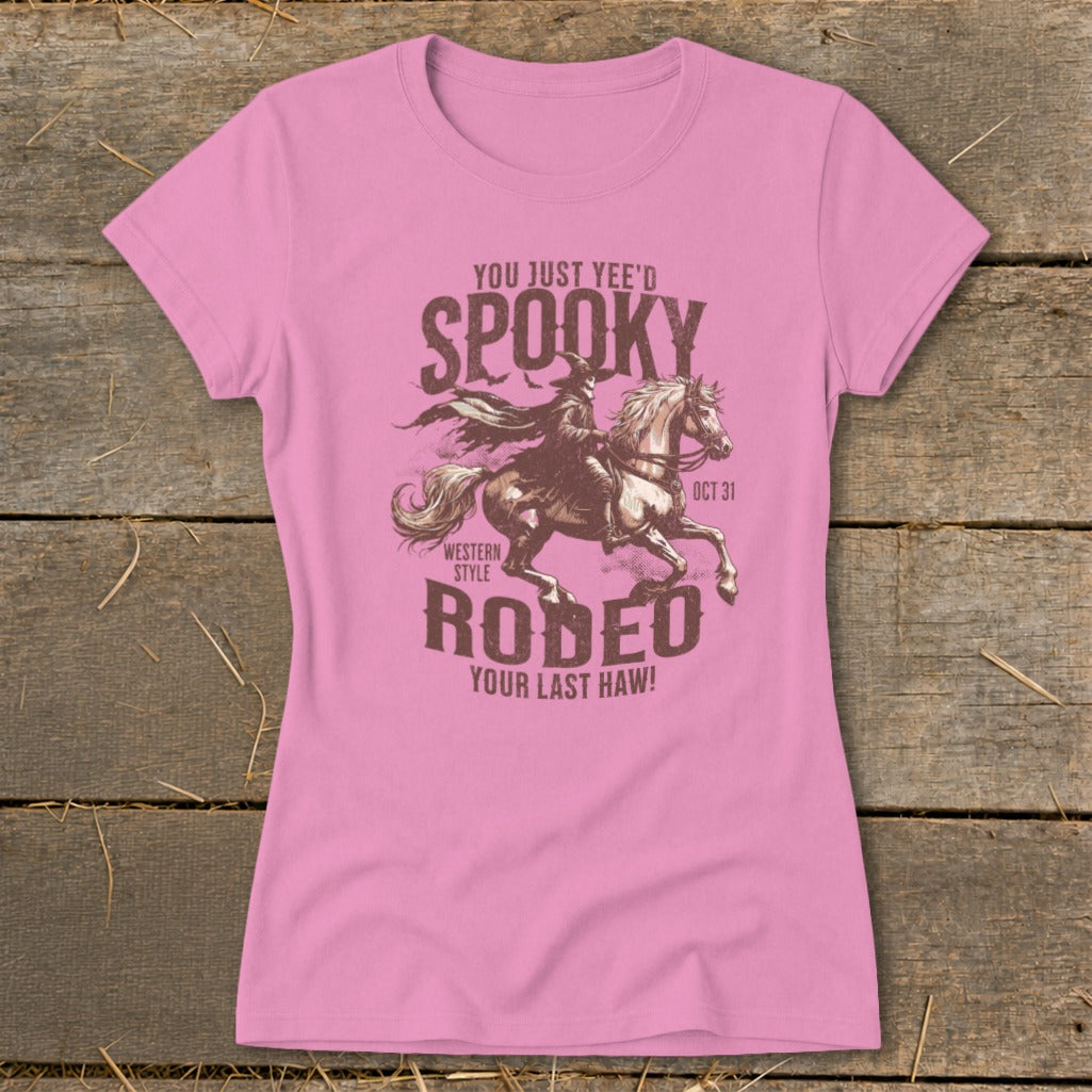 Pink t-shirt with "Spooky Rodeo" graphic featuring a skeleton on a horse and text.