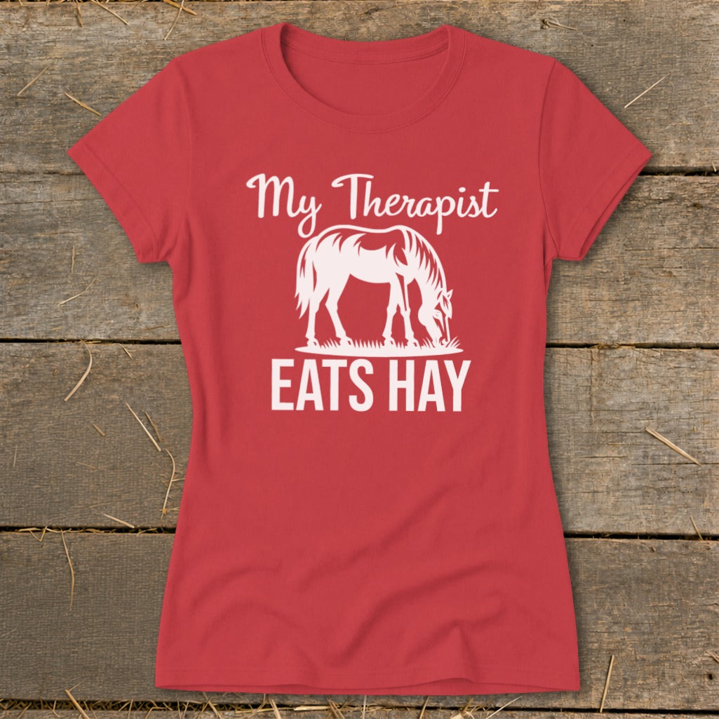 Red t-shirt with white graphic of a horse eating hay and text "My Therapist EATS HAY".