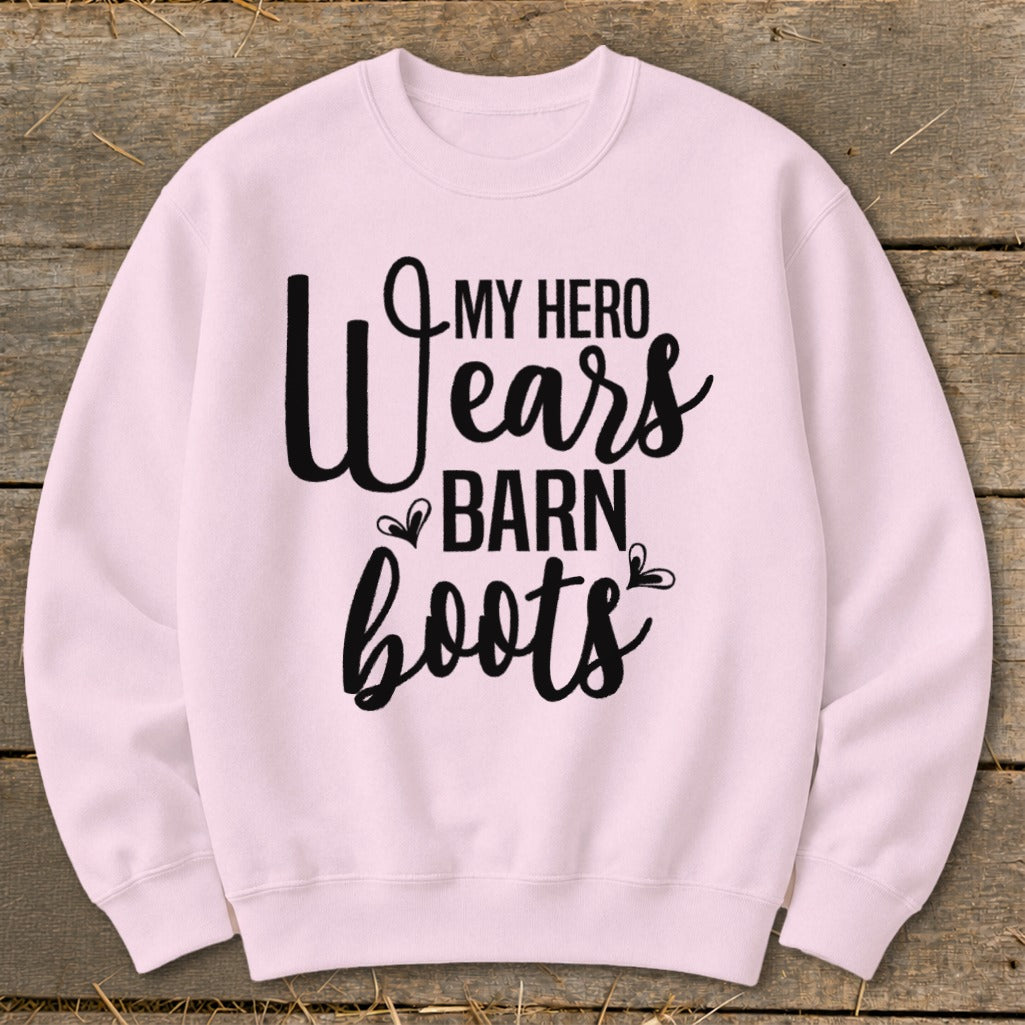 Pink sweatshirt with black text reading "My hero wears barn boots".
