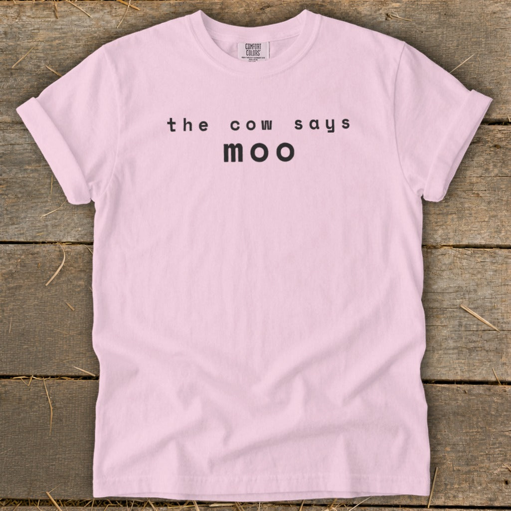 Pink t-shirt with black text "the cow says moo".