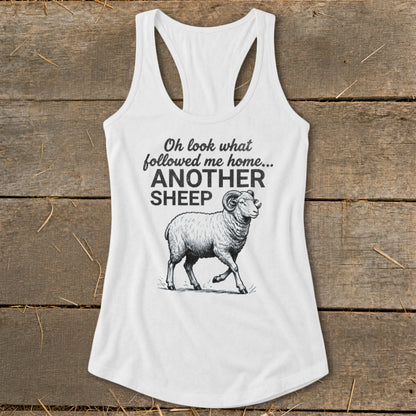 White tank top with graphic text "Oh look what followed me home... ANOTHER SHEEP" and sheep illustration.