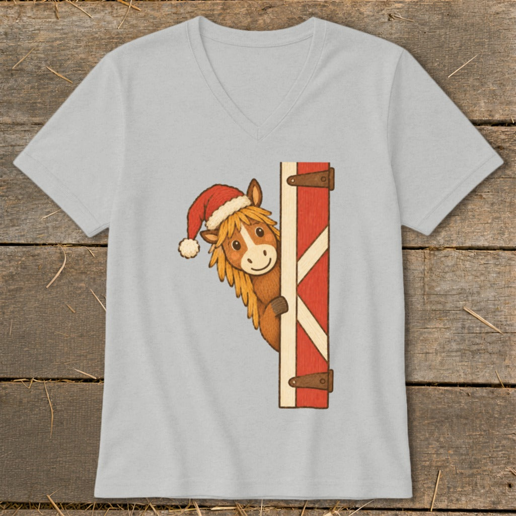 Illustration of a horse wearing a Santa hat peeking around a red barn door.