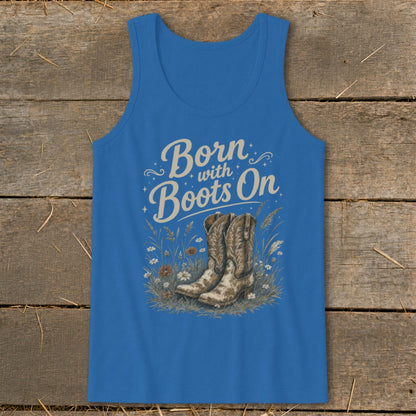 Blue tank top with "Born with Boots On" text and cowboy boots in grass.