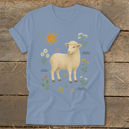 Light blue t-shirt with a cream sheep surrounded by flowers, sun, and water.