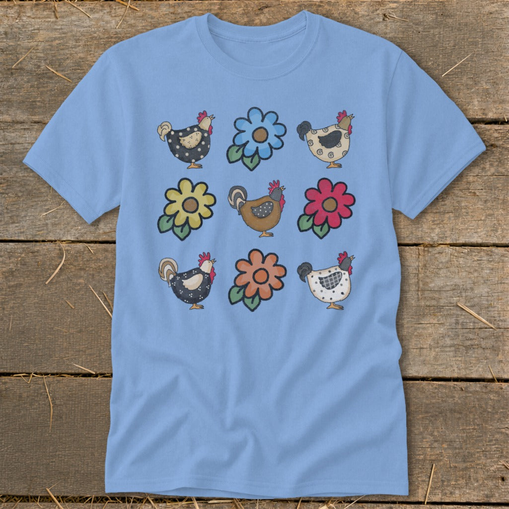 Light blue t-shirt with a repeating pattern of cartoon chickens and flowers.
