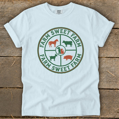 White t-shirt with "Farm Sweet Farm" text and farm animal icons in a circle.
