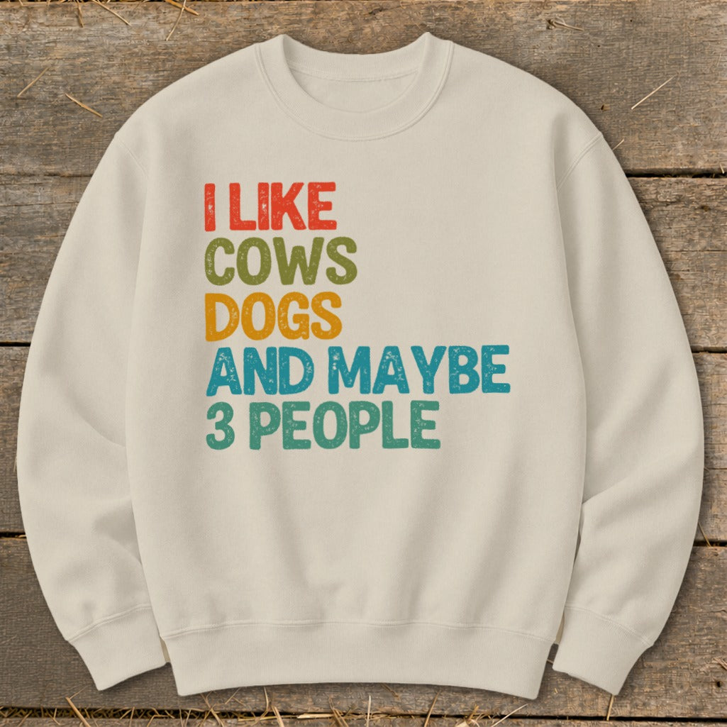 Cream sweatshirt with retro text: "I LIKE COWS DOGS AND MAYBE 3 PEOPLE".