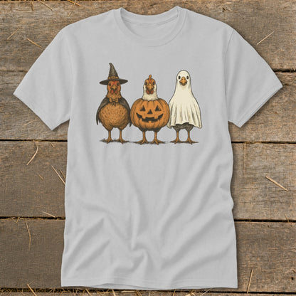 Three cartoon chickens dressed for Halloween: witch, pumpkin, and ghost.