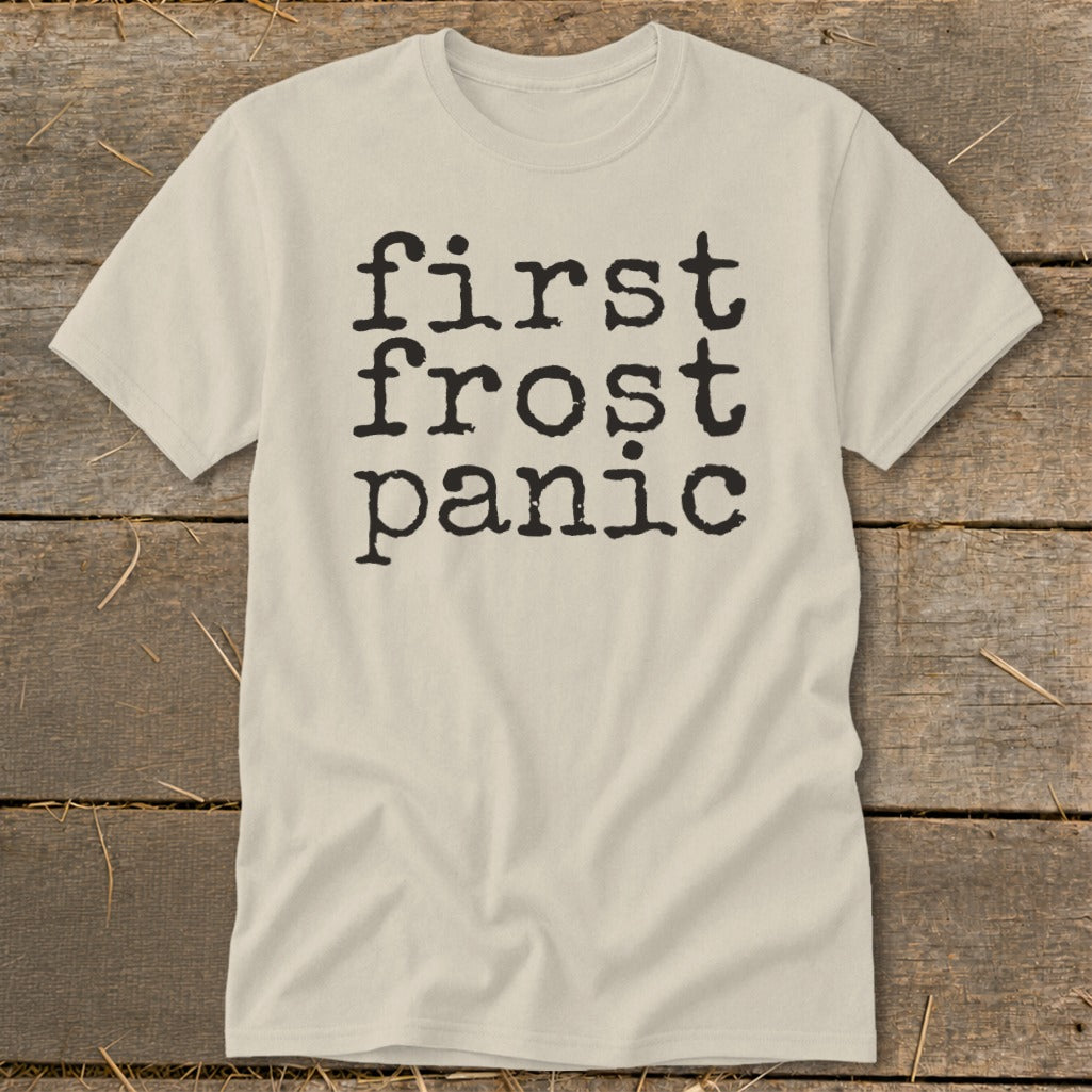 Light beige t-shirt with black text that reads "first frost panic" in stacked lines.