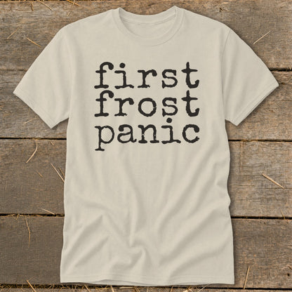 Light beige t-shirt with black text that reads "first frost panic" in stacked lines.