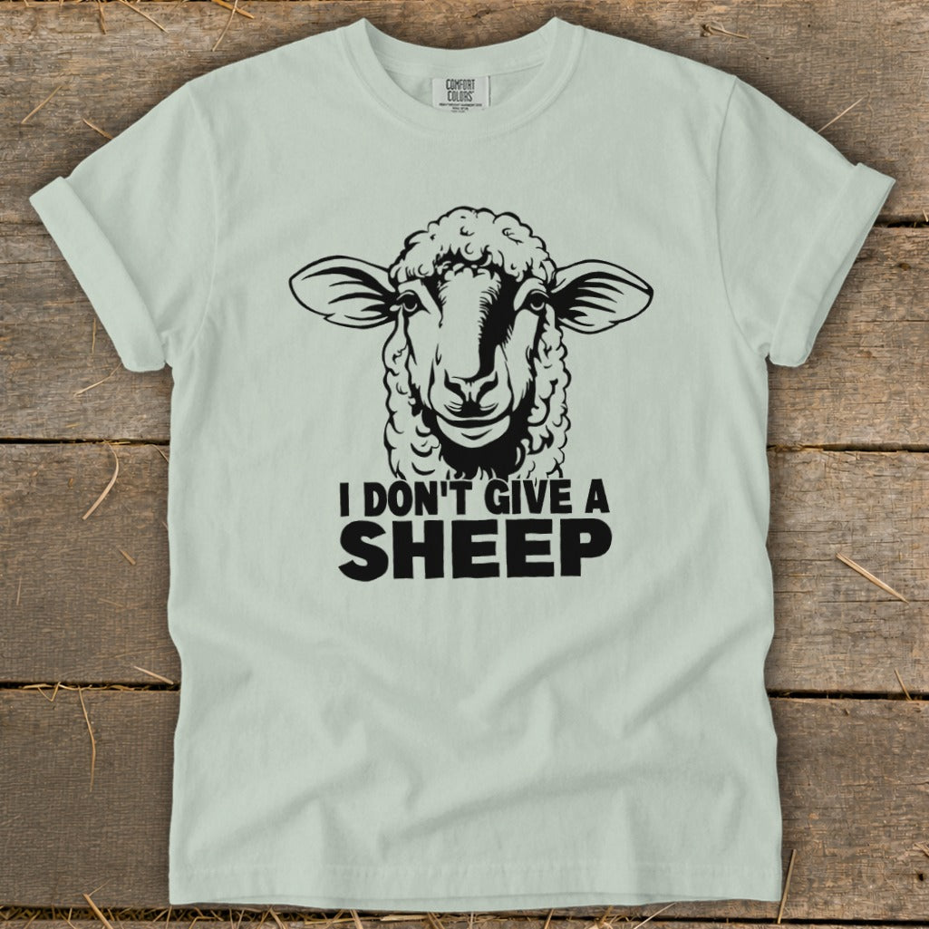Light green t-shirt with a black sheep illustration and text "I DON'T GIVE A SHEEP".