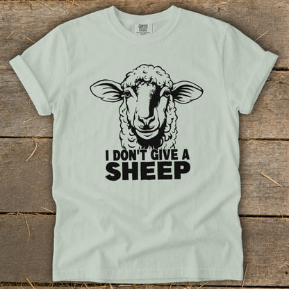 Light green t-shirt with a black sheep illustration and text "I DON'T GIVE A SHEEP".
