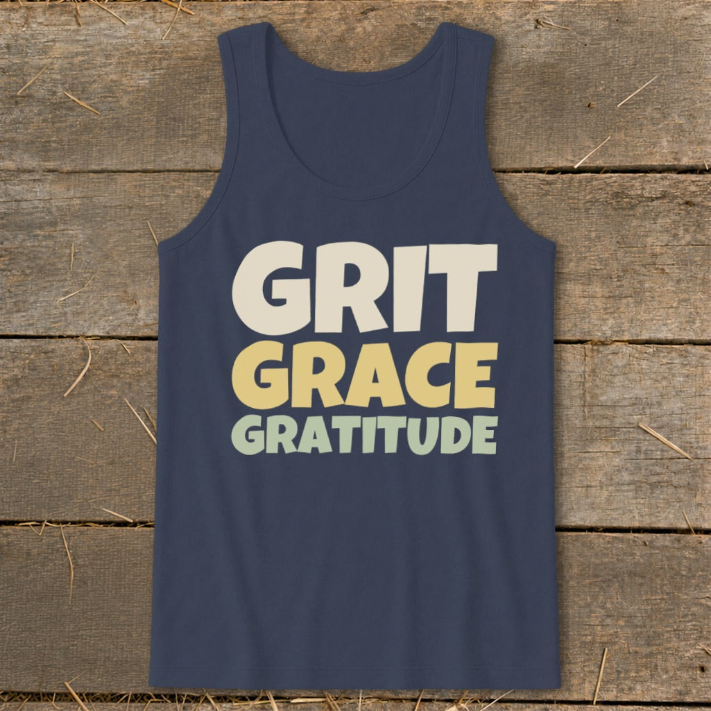 A dark blue tank top featuring the stacked text "GRIT GRACE GRATITUDE" in retro, multi-colored lettering.