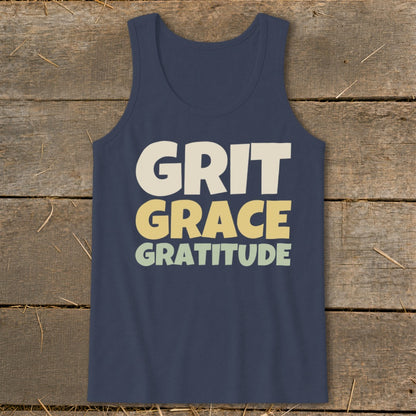 A dark blue tank top featuring the stacked text "GRIT GRACE GRATITUDE" in retro, multi-colored lettering.