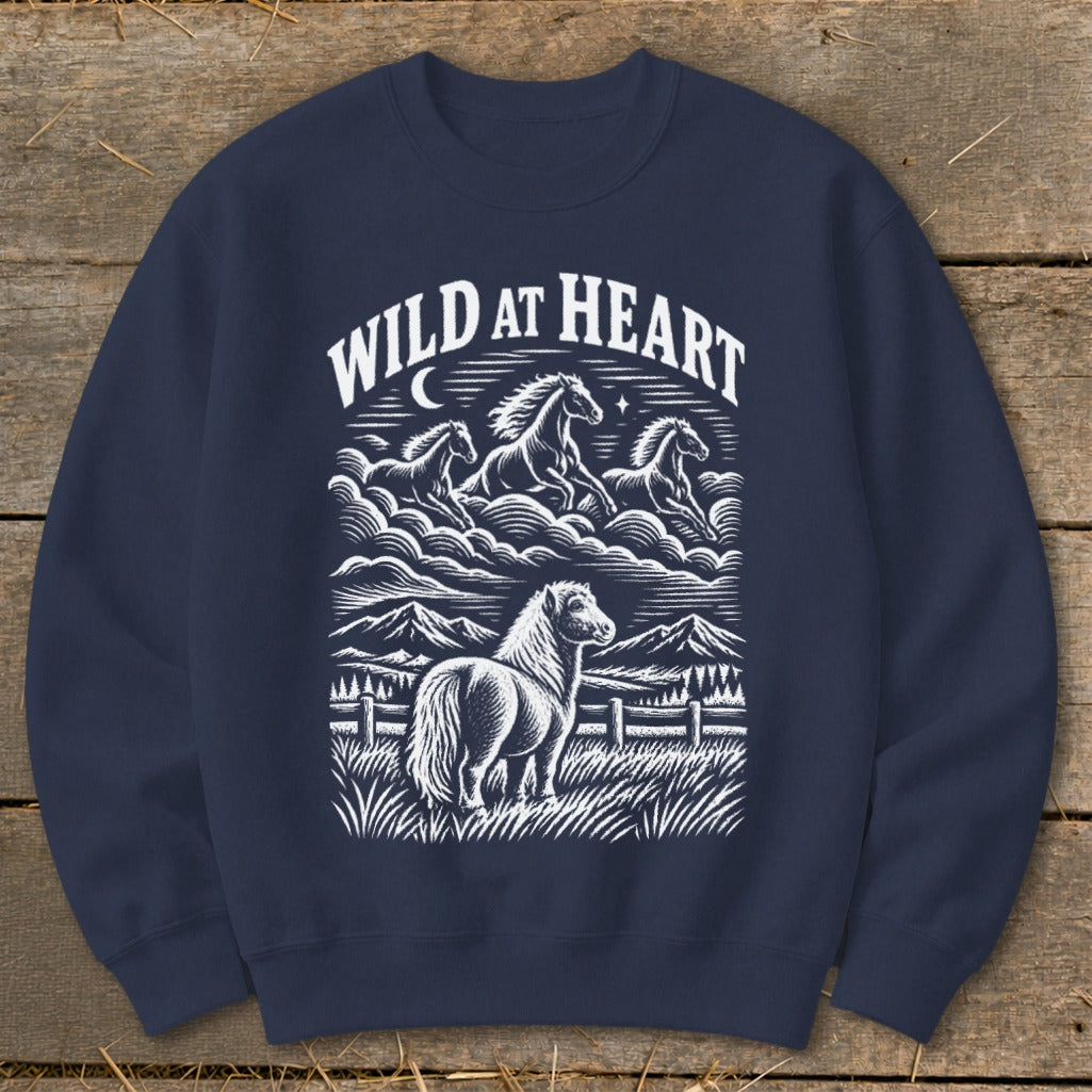 Navy sweatshirt with "Wild at Heart" text and horses in a landscape design.