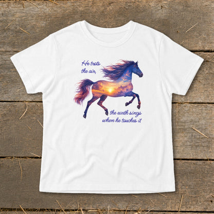 A white t-shirt featuring a galloping horse graphic filled with a sunset sky and quote text.