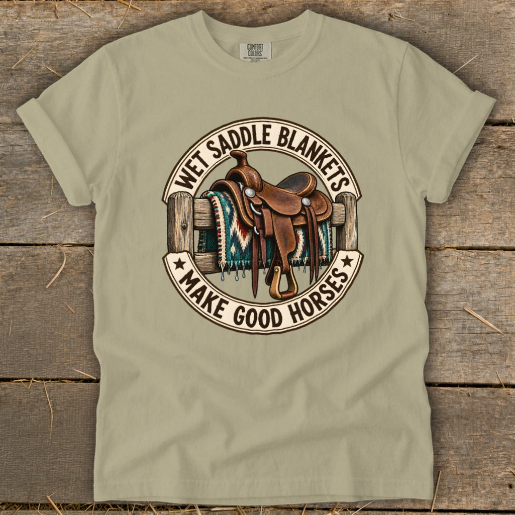 Cowboy saddle on fence with blanket and text "Wet Saddle Blankets Make Good Horses".