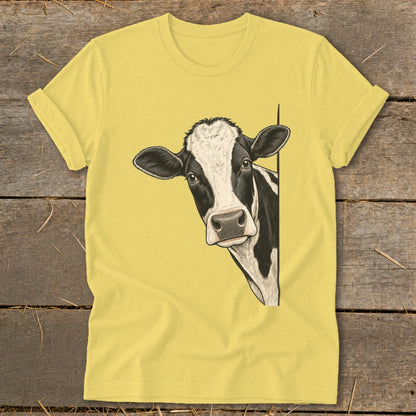 Black and white cow peeking from the side on a yellow t-shirt.