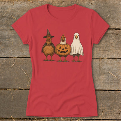 Three chickens dressed for Halloween: witch, pumpkin, and ghost.