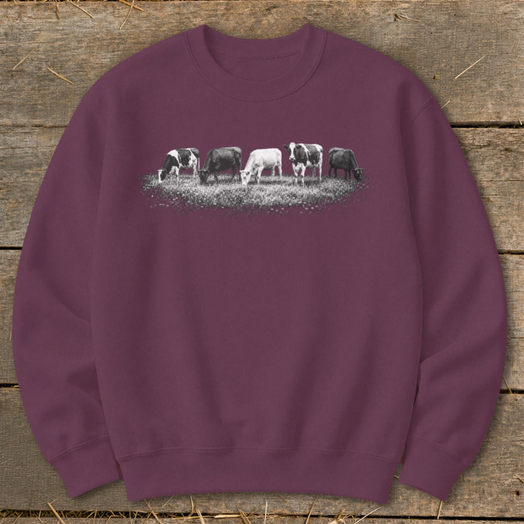 Burgundy sweatshirt with a graphic of five cows grazing in a field.