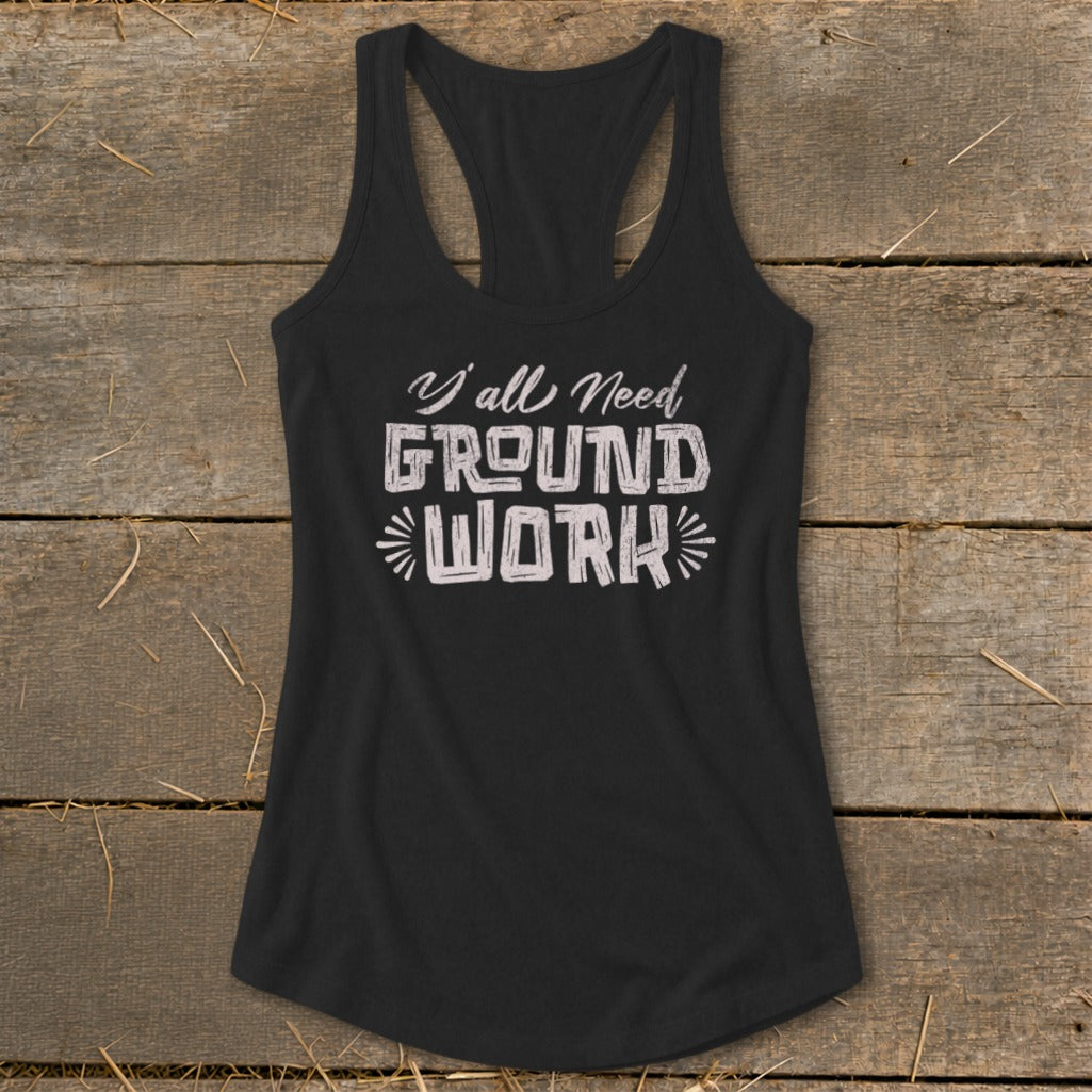 Black racerback tank top with "Y'all Need GROUND WORK" graphic.