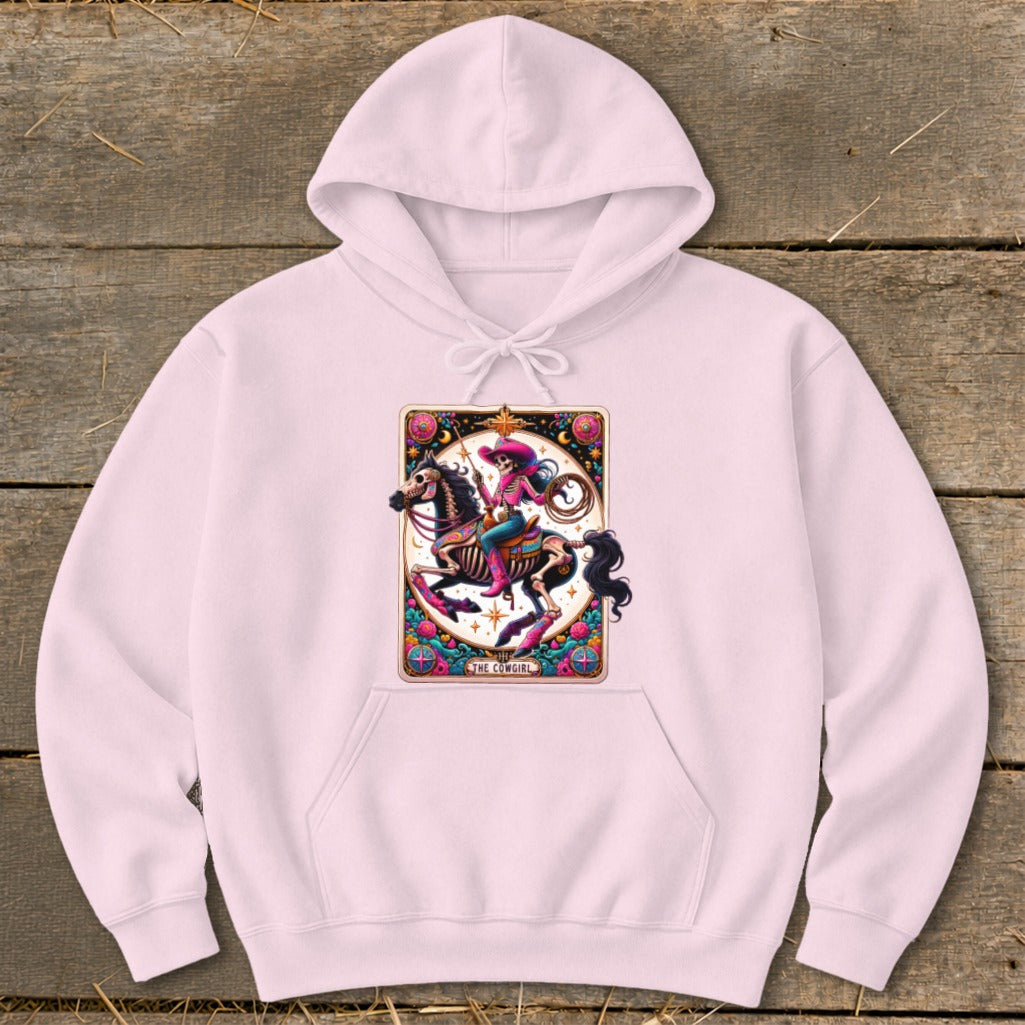 Pink hoodie with a "The Cowgirl" tarot card design featuring a skeletal cowgirl on a horse.
