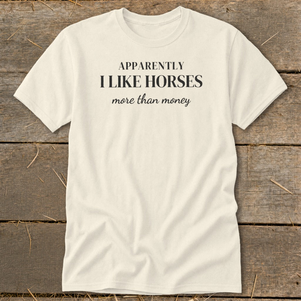 Cream t-shirt with black text that reads "APPARENTLY I LIKE HORSES more than money".
