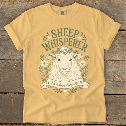 Yellow t-shirt with "Sheep Whisperer" text and a sheep wearing a flower crown.