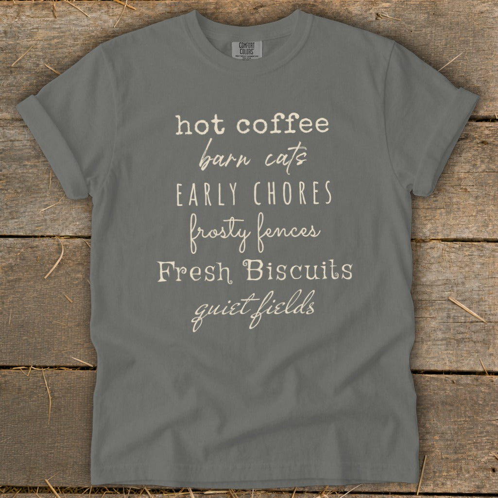 Gray t-shirt with list of text: hot coffee, barn cats, early chores, frosty fences, fresh biscuits, quiet fields.