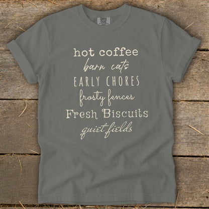 Gray t-shirt with list of text: hot coffee, barn cats, early chores, frosty fences, fresh biscuits, quiet fields.