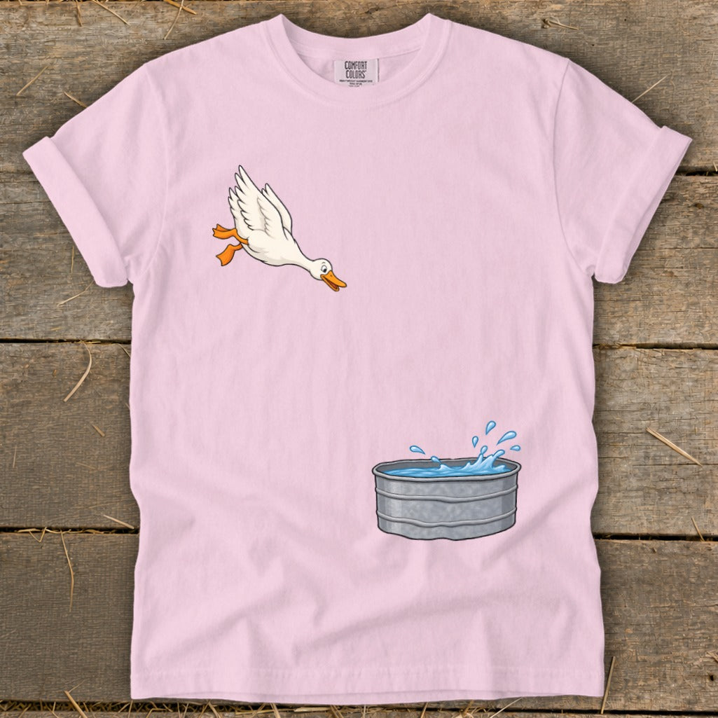 Pink t-shirt with cartoon duck jumping into a metal water tub.