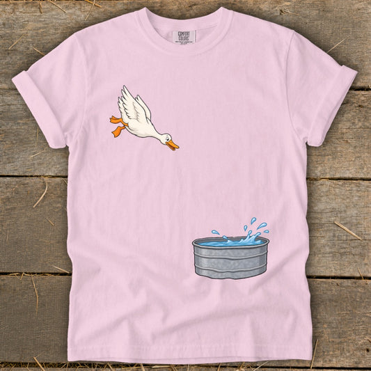 Pink t-shirt with cartoon duck jumping into a metal water tub.