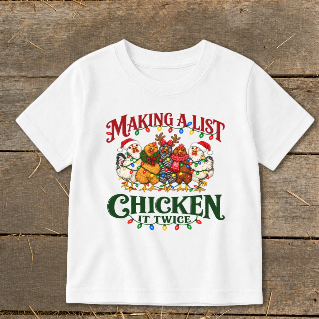 White t-shirt with chickens wearing Santa hats, decorated with Christmas lights and text.