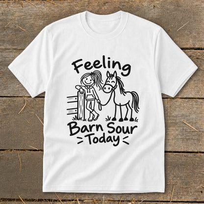 White t-shirt with black graphic of a girl leaning on a fence next to a horse with text "Feeling Barn Sour Today".