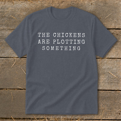 Gray t-shirt with white text that reads "THE CHICKENS ARE PLOTTING SOMETHING".