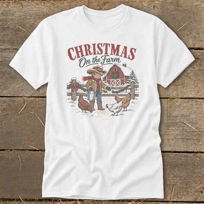 White t-shirt with "Christmas On the Farm" text and farm scene illustration.