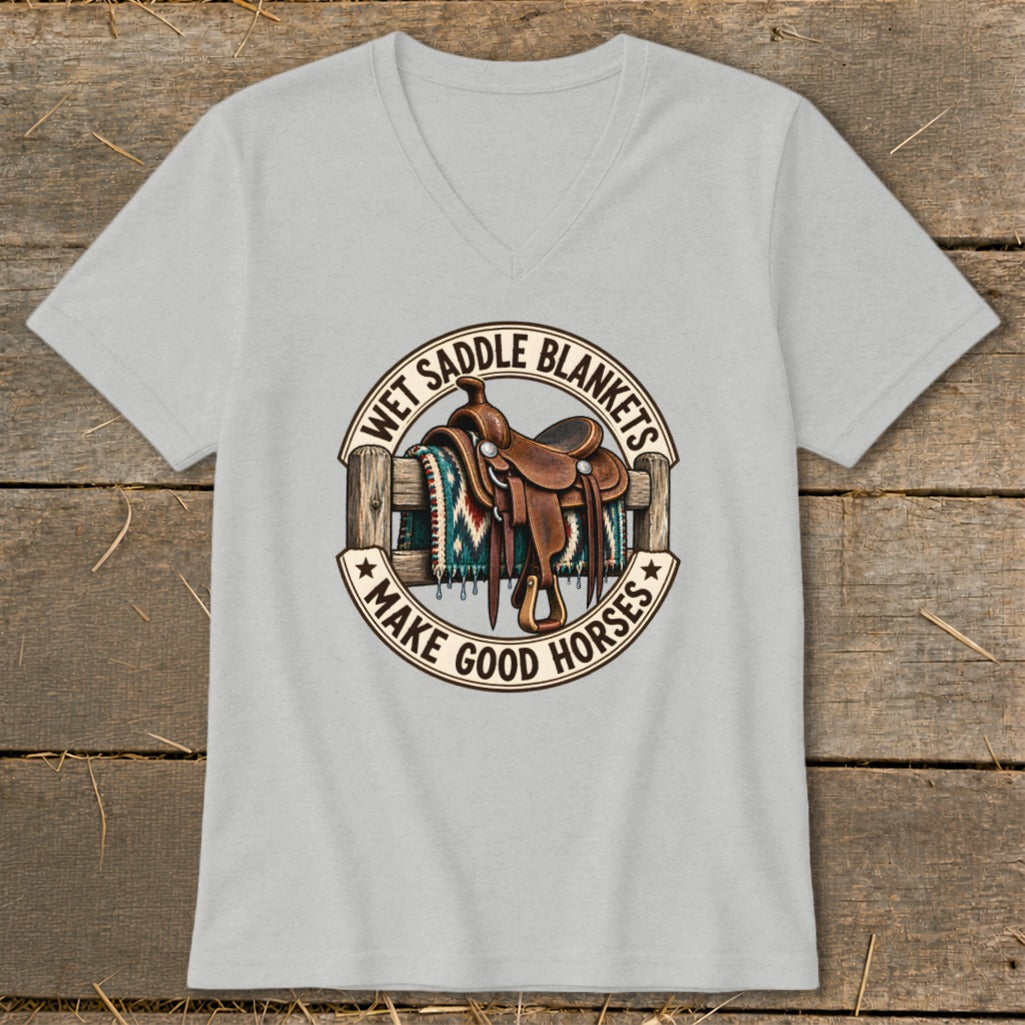 Western saddle on a fence with text "Wet Saddle Blankets Make Good Horses".
