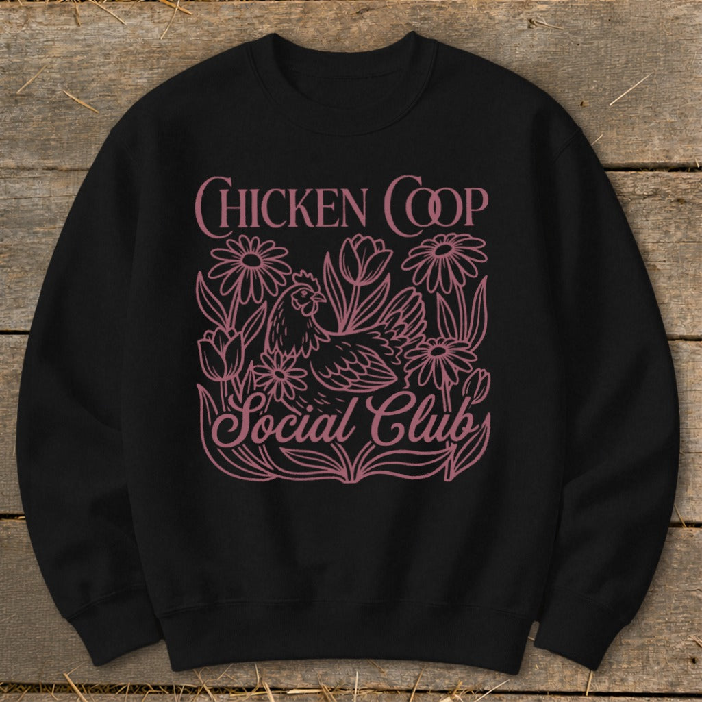 Black sweatshirt with pink "Chicken Coop Social Club" text and chicken graphic.