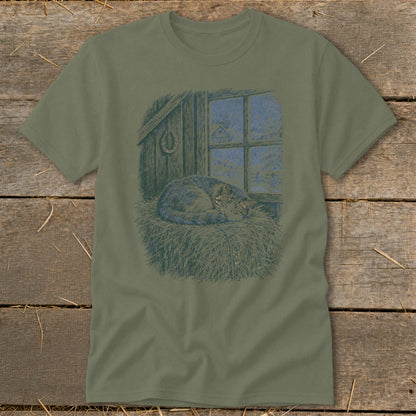 T-shirt with sleeping cat on hay in front of snowy barn window.