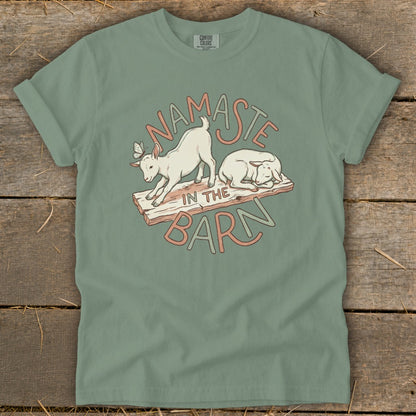 T-shirt with a graphic of two goats and the text "Namaste in the Barn".