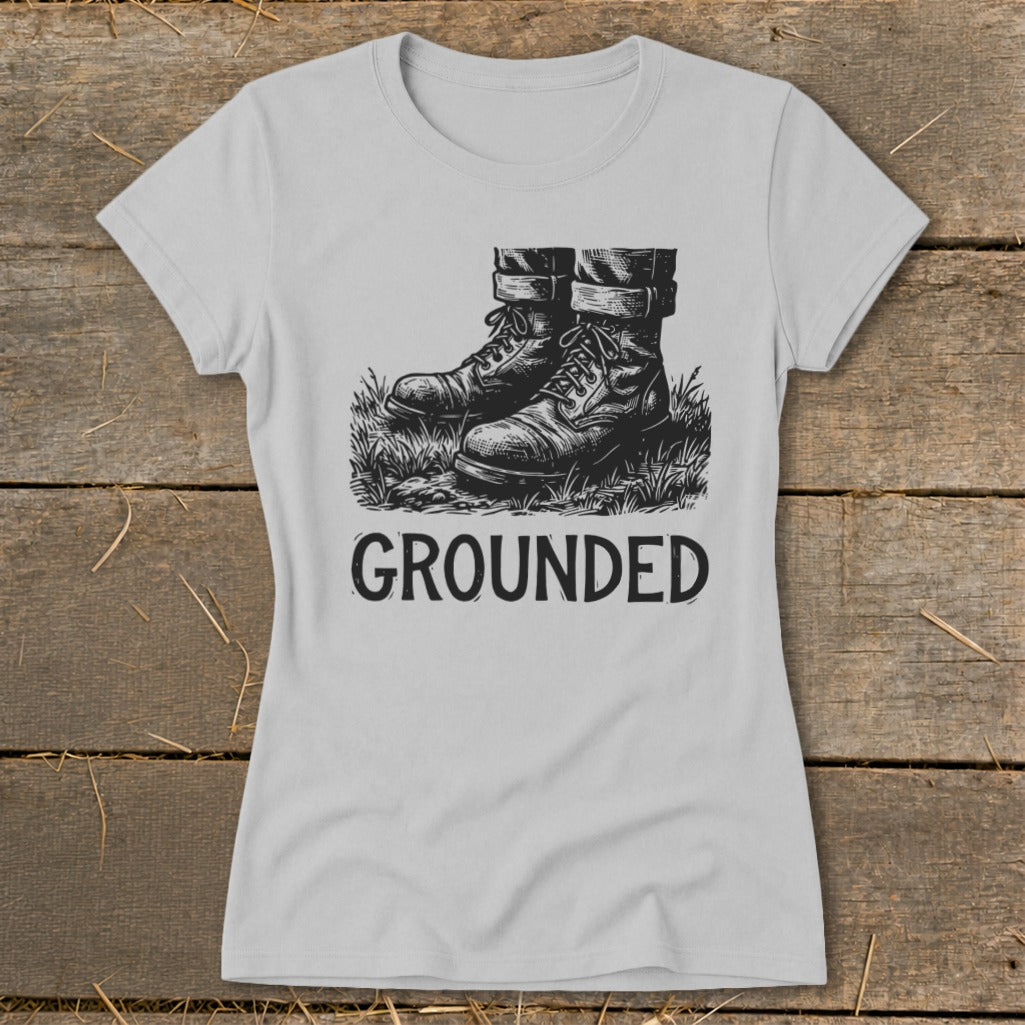 Light grey t-shirt with black graphic of boots in grass and text "GROUNDED".