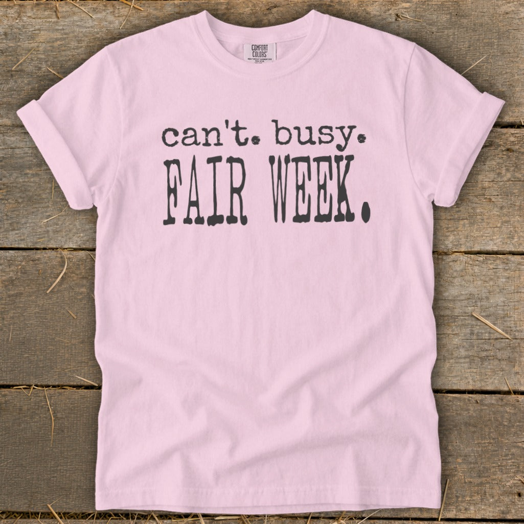 Pink t-shirt with black text that says "can't. busy. FAIR WEEK."