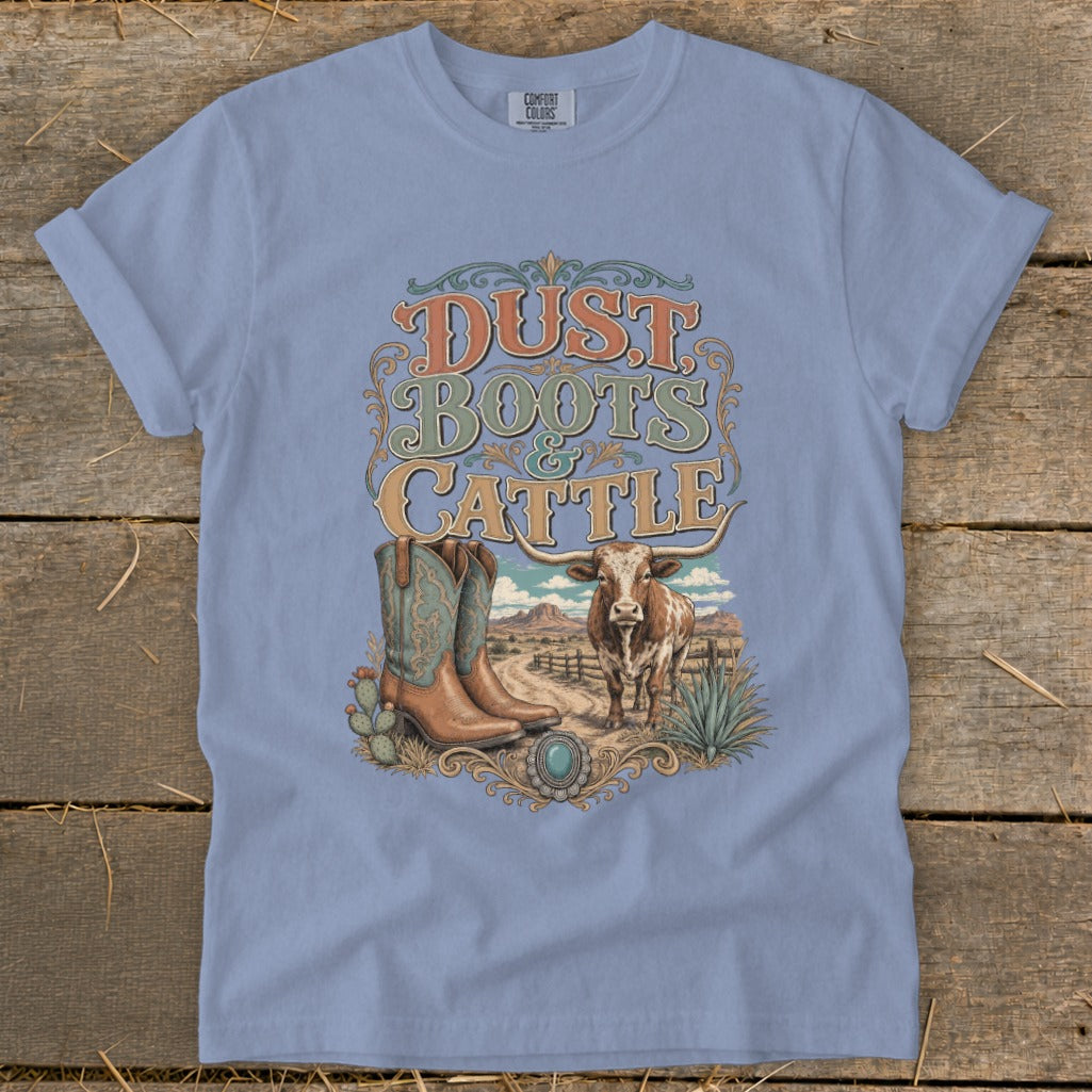 Light blue t-shirt with "Dust Boots & Cattle" graphic featuring boots, a steer, and desert landscape.