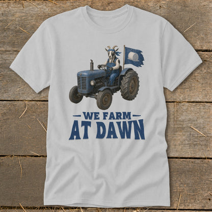 Goat wearing overalls drives blue tractor with flag; text reads "WE FARM AT DAWN."