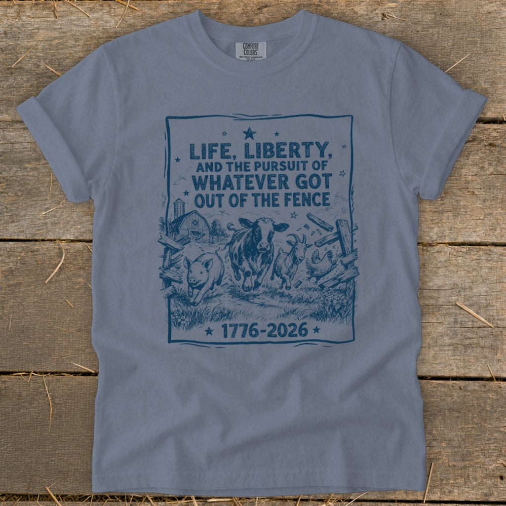 Blue t-shirt with farm animals and text about life, liberty, and the pursuit of what got out of the fence.