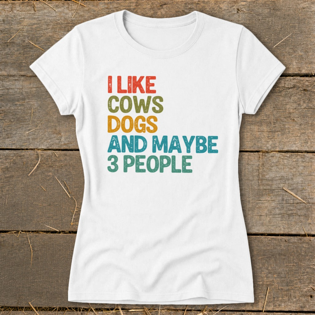 White t-shirt with "I like cows dogs and maybe 3 people" text.
