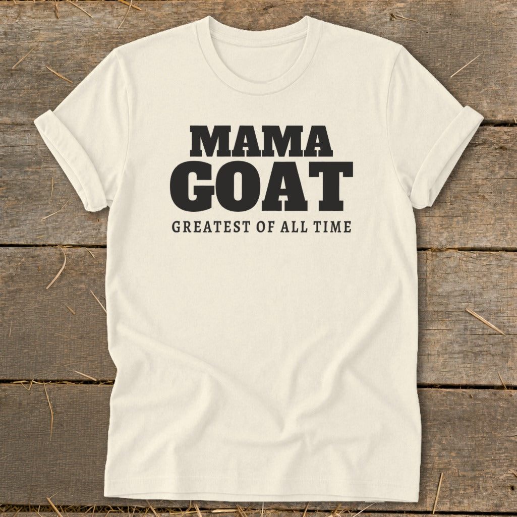 Cream t-shirt with black text "MAMA GOAT GREATEST OF ALL TIME".