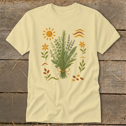 Light yellow t-shirt with botanical illustration of herbs, sun, and flowers.