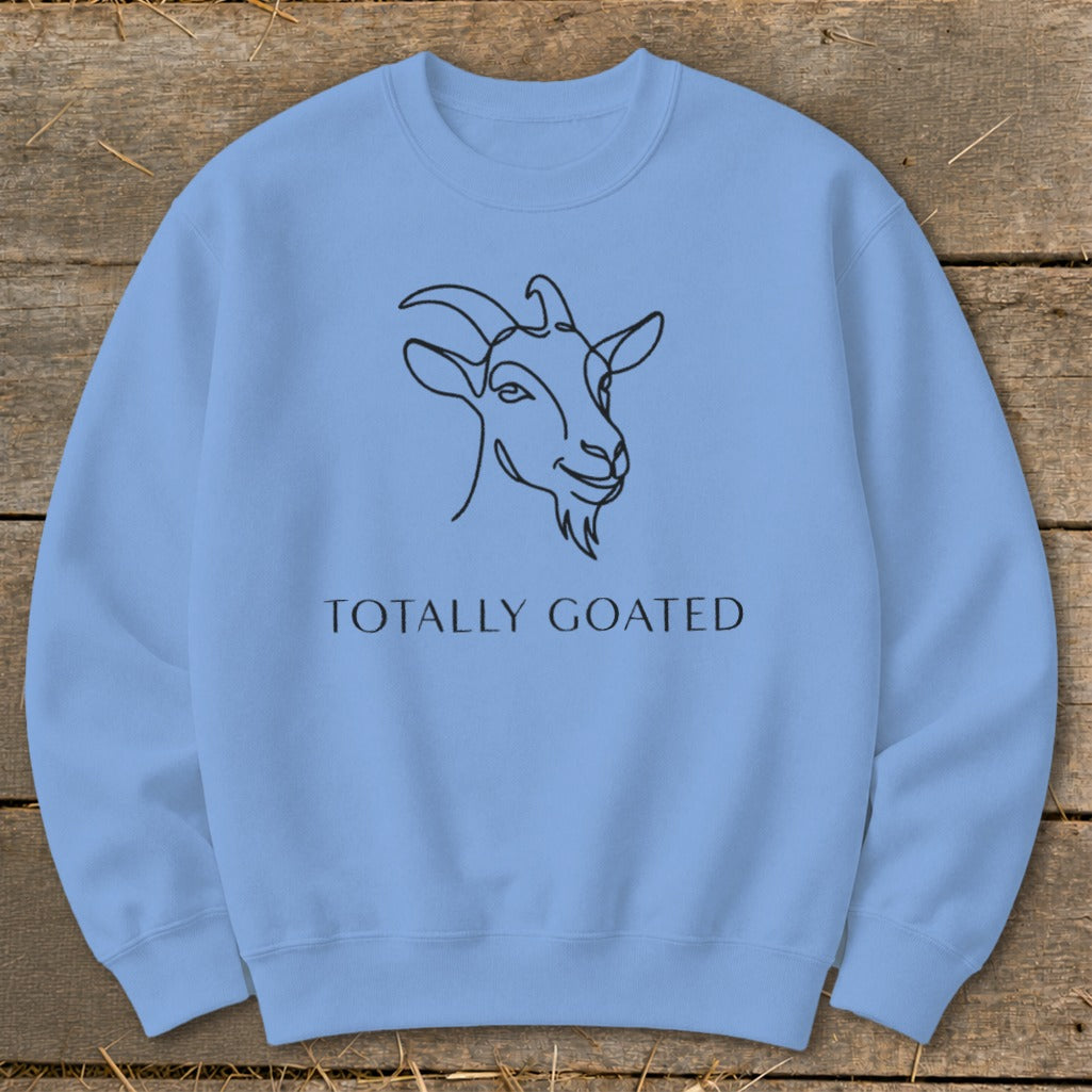Light blue sweatshirt with a black line drawing of a goat's head and the text "TOTALLY GOATED."
